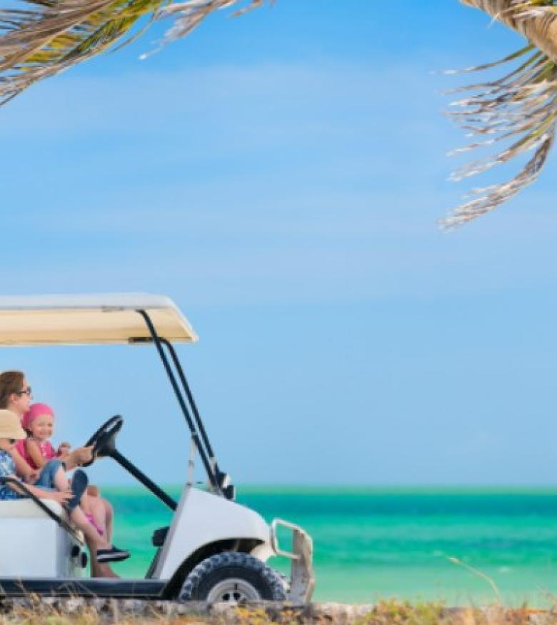 Where Can I Find the Best Golf Cart Accident Attorneys in Big Pine Key, Florida - Family riding a golf cart by the beach