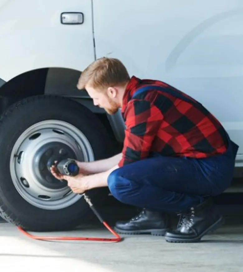 Tampa Car Repair Injury - Man fixing car tires