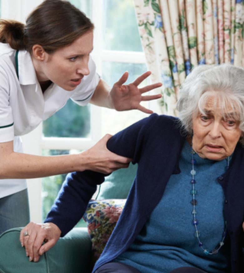 A caregiver aggressively handling an elderly woman, highlighting the need for a Nursing Home Abuse Lawyer in Covington to provide legal assistance.