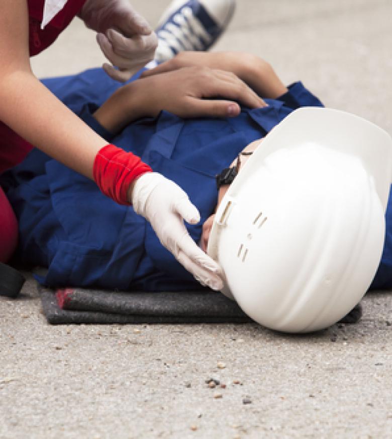 Injured construction worker on ground, seek a construction accident lawyer in Reno.