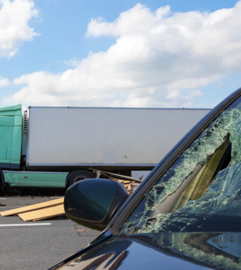 A damaged car and a truck after a collision, highlighting the need for a Truck Accident Attorney in Honolulu.