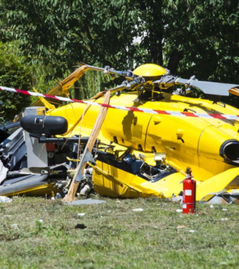 A yellow helicopter crashed on the ground with debris around, emphasizing the need for a Helicopter Accident Attorney in Bowling Green to provide legal assistance.