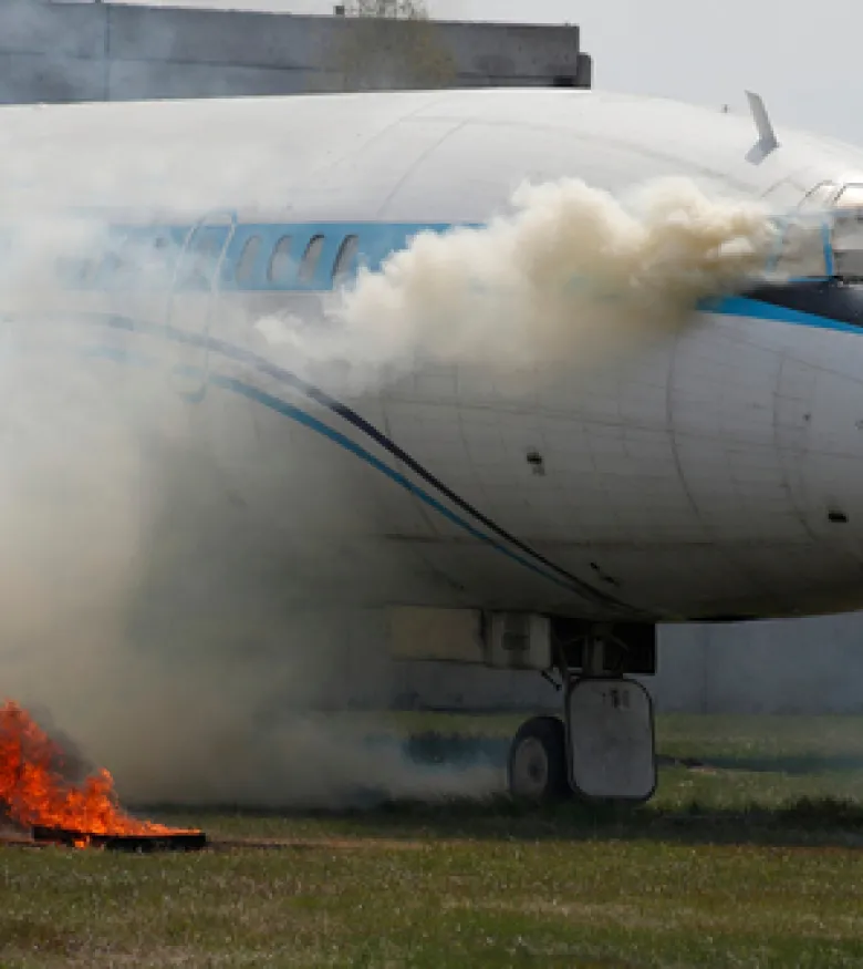 An airplane on the ground with smoke and fire, highlighting the need for an Aviation Accident Lawyer in Gainesville to provide expert legal assistance