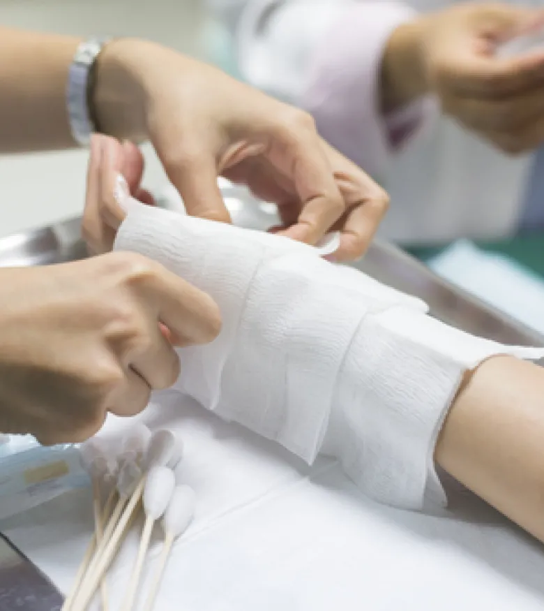 Medical staff treating a severe burn on a patient's arm, contact a burn injury attorney in The Bronx.