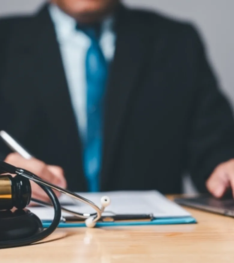 A lawyer at a desk with legal documents and a gavel, emphasizing the need for an Injury Attorney in Orange Park to provide legal assistance