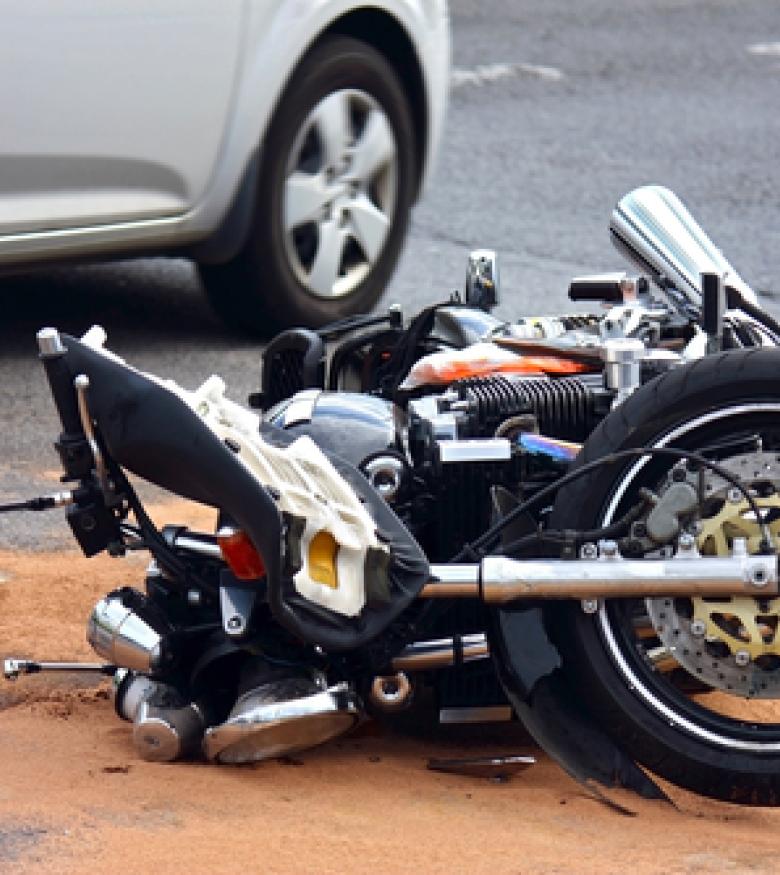 A motorcycle lying on the road after an accident, highlighting the need for a Motorcycle Accident Attorney in The Bronx to provide legal assistance.