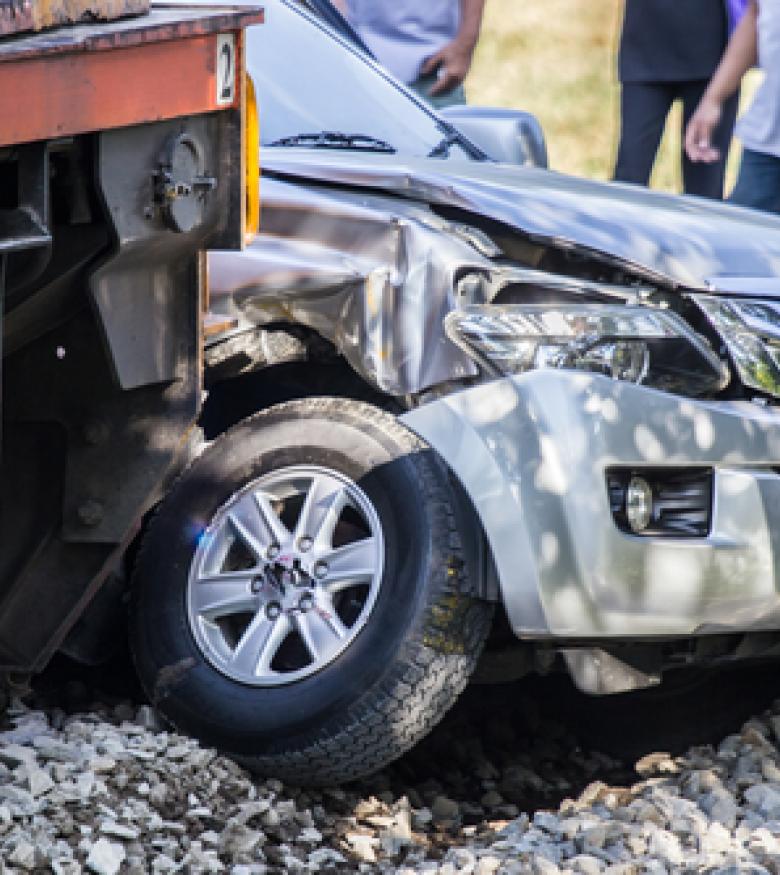 A car severely damaged by a collision with a train, highlighting the need for a Train Accident Lawyer in Gainesville to provide legal assistance.