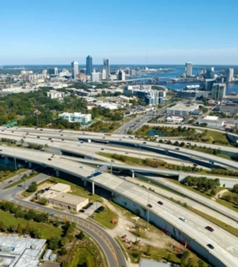 Aerial view of Jacksonville's interwoven highways and skyline, prime location for personal injury lawyers.
