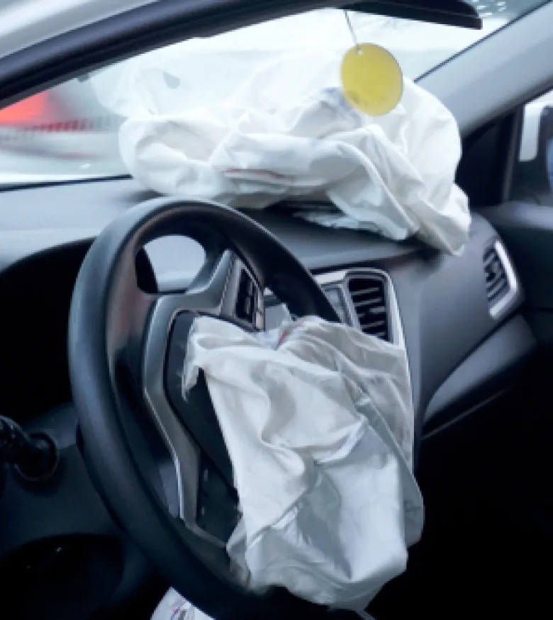 Airbag deployment aftermath in a car with visible damage, illustrating the need for an attorney specializing in airbag injuries in Ocala.