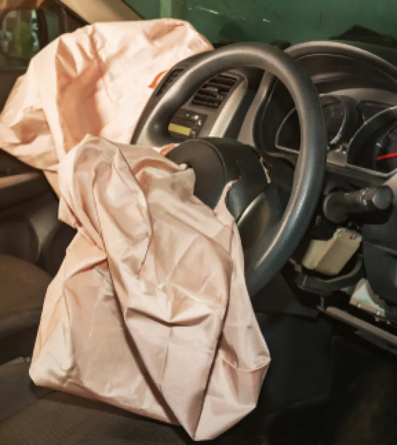 Deployed airbags inside a car highlighting the scene for Airbag Injuries in Paducah.