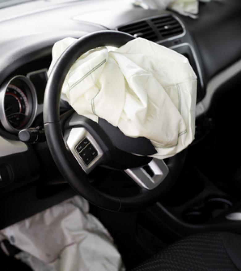 Interior view of a car with deployed airbags, illustrating the aftermath of an accident for Airbag Injuries in Macon
