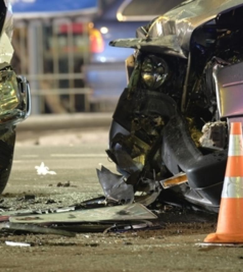 The aftermath of a severe car crash, with damaged vehicles and a traffic cone in view, illustrating the need for a Car Wreck Attorney in Waltham.