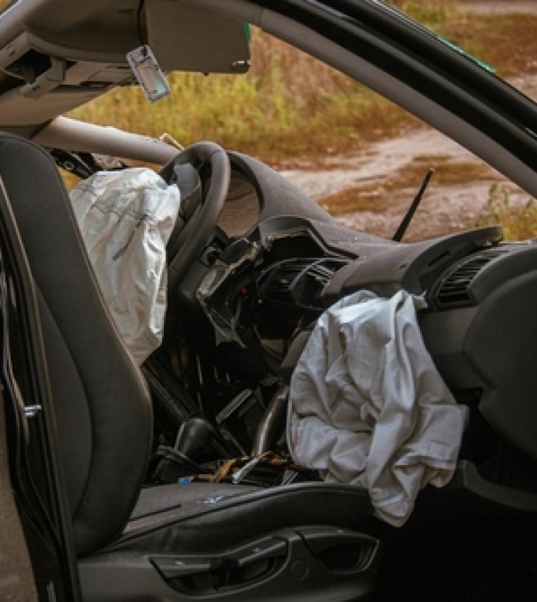 Car interior with deployed airbags after an accident, illustrating Airbag Injuries in Little Rock.