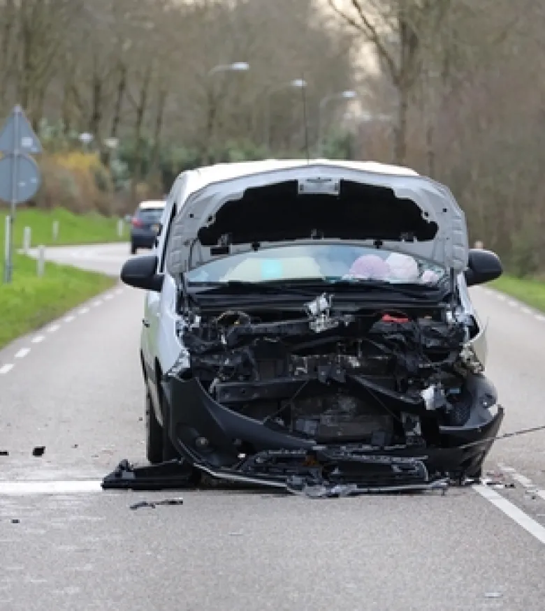 A damaged car on a road with a crumpled front, illustrating the need for a Car Wreck Lawyer in Naples.