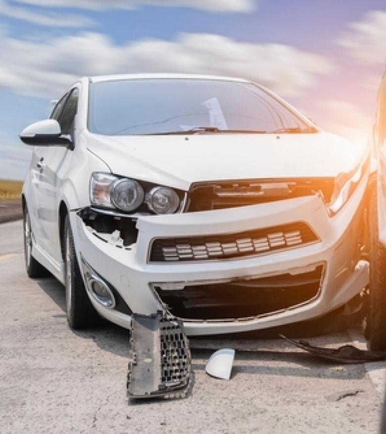 Damaged white car after a collision, emphasizing the need for a car wreck lawyer in Hilton Head Island.