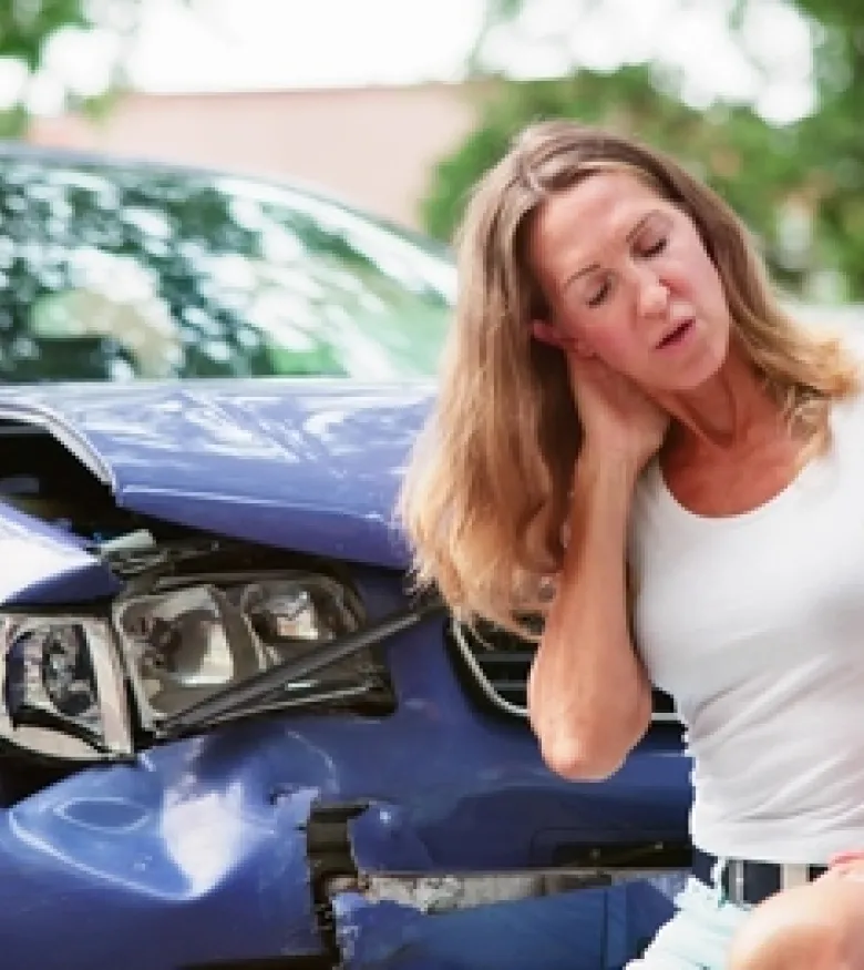 Woman holding her neck in pain after a car accident, highlighting the need for a car wreck lawyer in Prestonsburg.