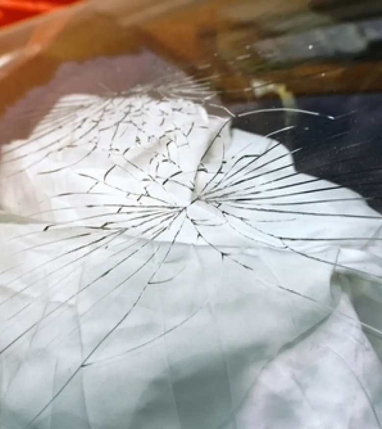 Airbag Injuries in Marietta: Cracked windshield and deployed airbag after a car accident, highlighting potential injuries caused by airbags.