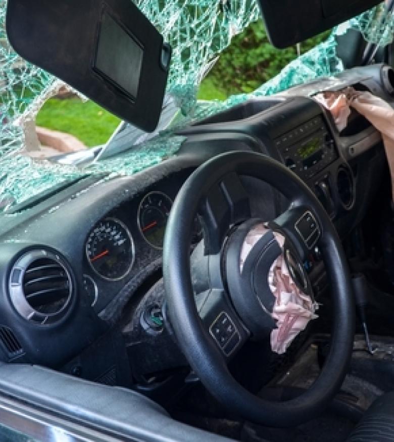 Interior of a vehicle with deployed airbags highlighting airbag injuries in St. Augustine.