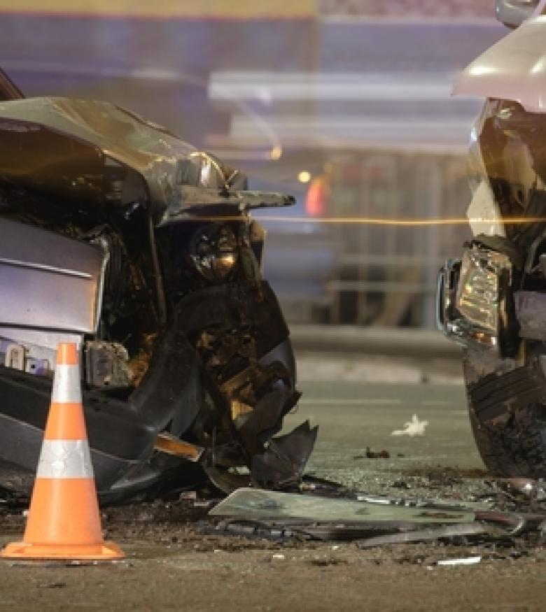 Damaged vehicles after a car wreck at night with a traffic cone, illustrating the need for a Car Wreck Lawyer in Paducah