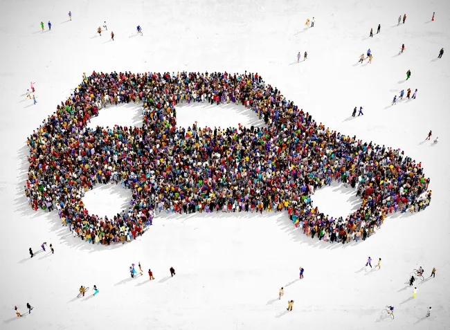 People forming shape of car