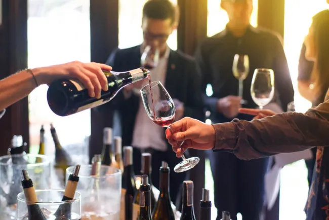 People enjoying wine tasting at a winery, demonstrating safe practices for responsible drinking and wine pouring.