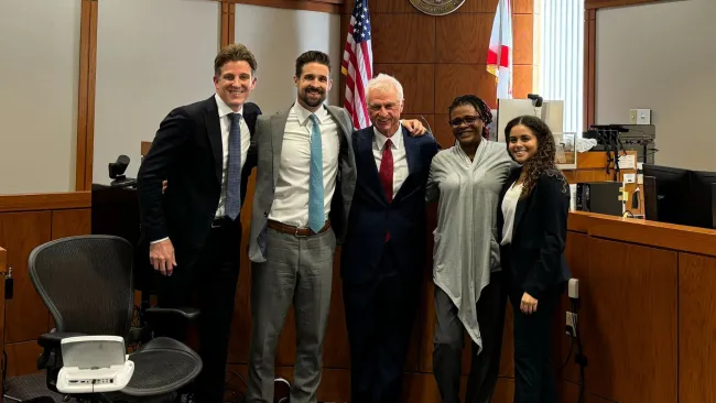 Image of Morgan & Morgan attorneys Crosby Crane, Jonathan Brozyna, Bob Joyce, and Karighan Walker with Jessina