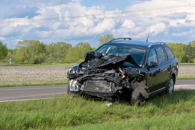 Totaled car on the side of the road