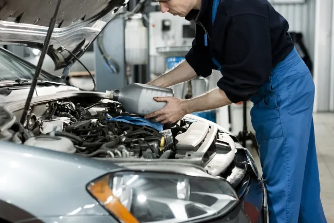 Mechanic servicing a car in an auto shop