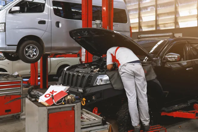 Mechanic working on a car at an auto shop