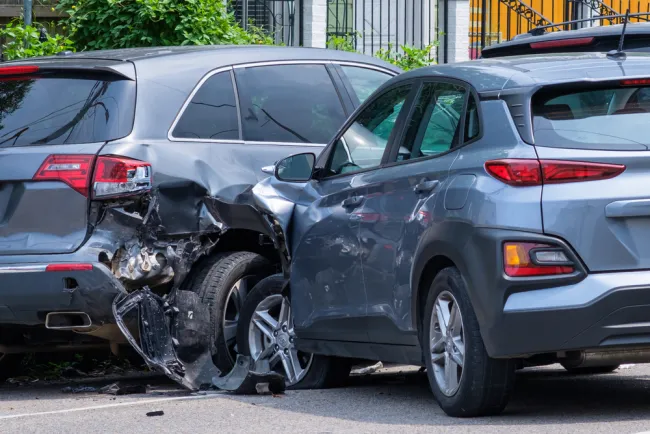 Two grey SUVs crashed into each other