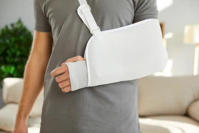 Man with an injured arm in a sling