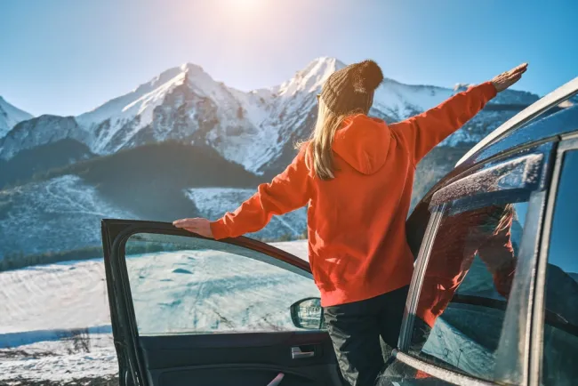 girl driving car in the winter