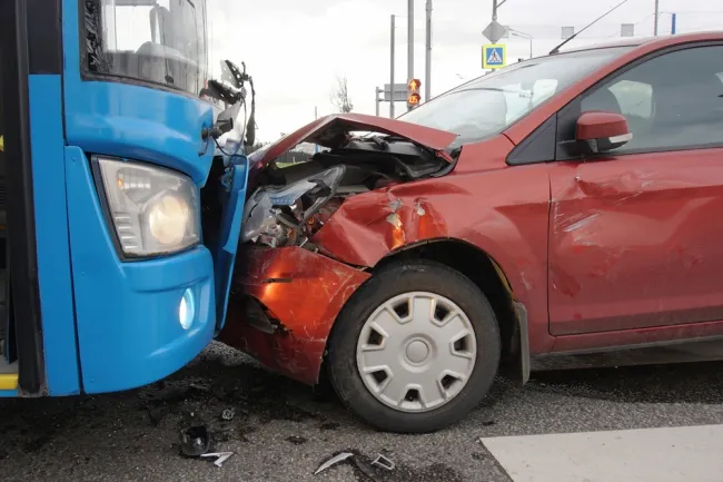 Red car crashed into blue bus