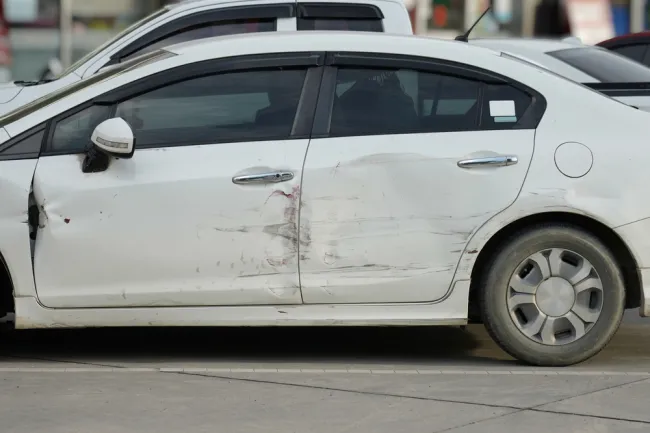 White car with a damaged door