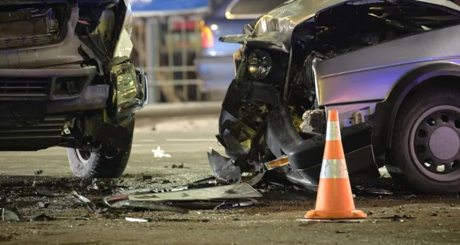 Two damaged cars after an accident with a cone