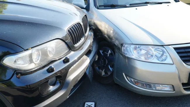 Front end of a car crashed into the front of another car