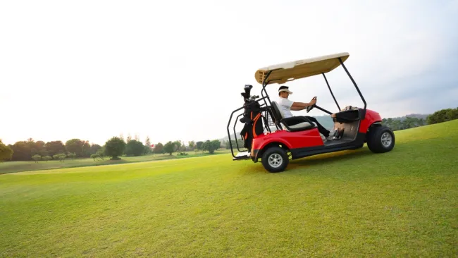 Man driving a golf cart