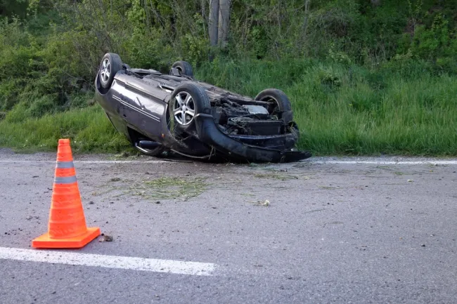 Car flipped upside down on the road