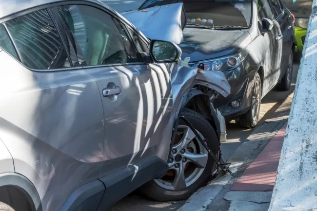 Grey car crashed into a parked car