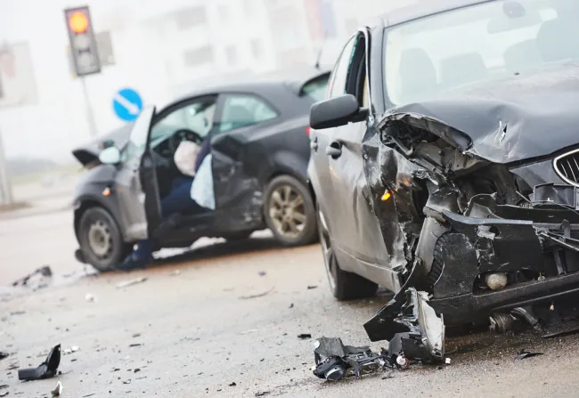 Two black cars with severe damage after an accident