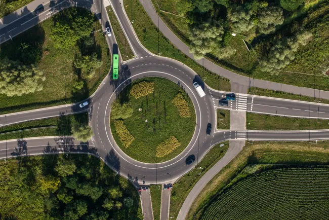 Aerial view of cars driving around a roundabout