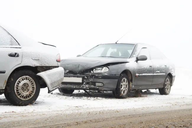 Two cars after an accident in the snow