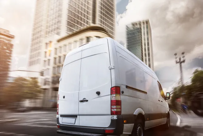 Van driving through a city