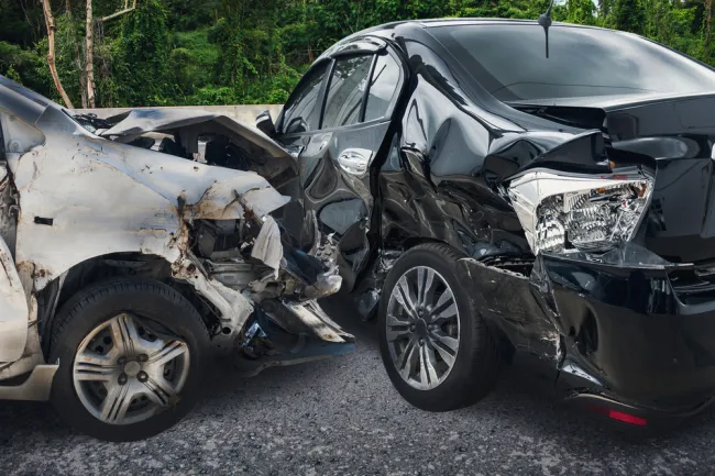 Grey car smashed into a black car