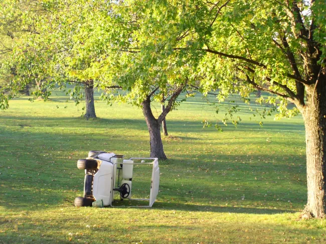 Golf cart flipped on its side