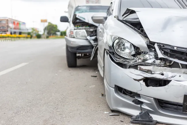 Grey truck that has rear ended a grey sedan