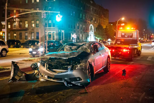 Damaged car getting towed after an accident on the street