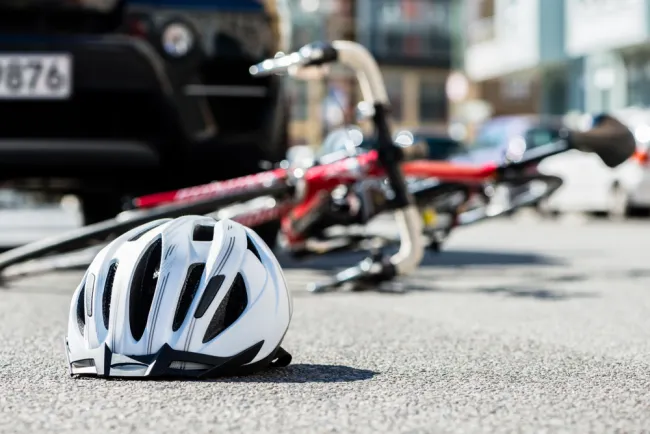 Bike helmet and bike fallen down on the road 