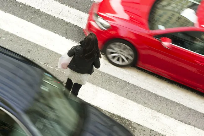 Pedestrian Fatalities Are Up in Georgia: Why Is it Difficult to Cross the Street? - A woman crossing the pedestrian lane