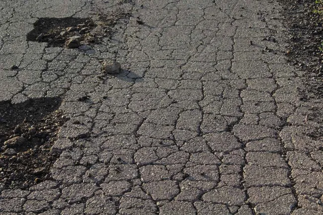 Top 4 Concerns That Prestonsburg Drivers Have When on the Road - An asphalt road with cracks